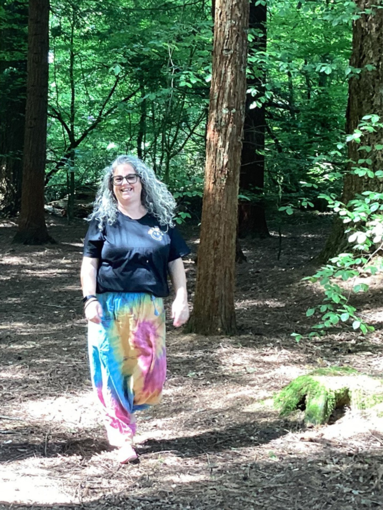 Kelly walking in the woods